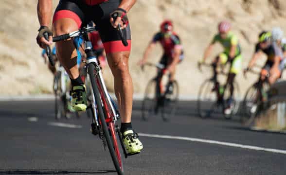 A man cycling up hill