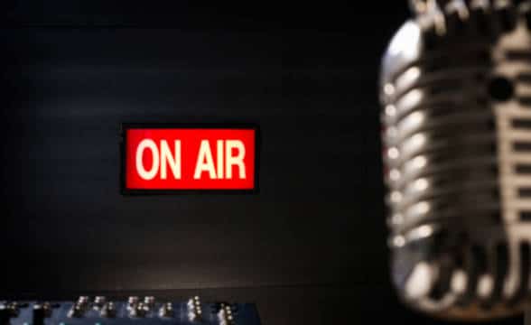 Light on air sign in a radio booth and a retro microphone