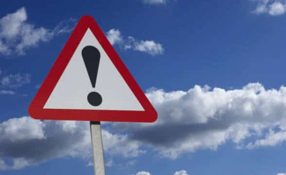 Red and white triangular road sign with a black exclamation mark.