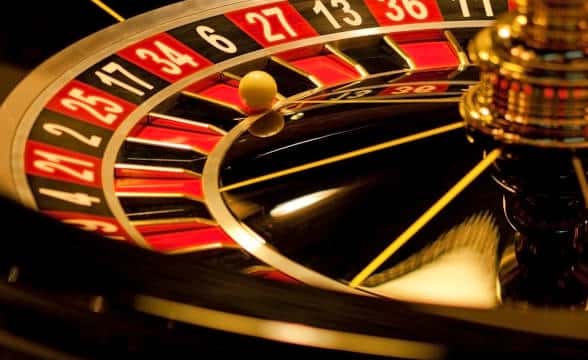 Roulette table and a ball spinning.