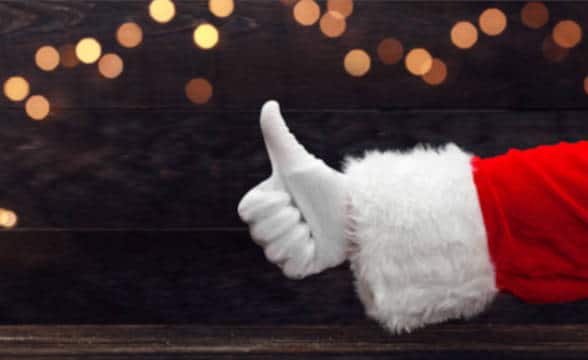 Close up photo of Santa's hand showing a thumb up