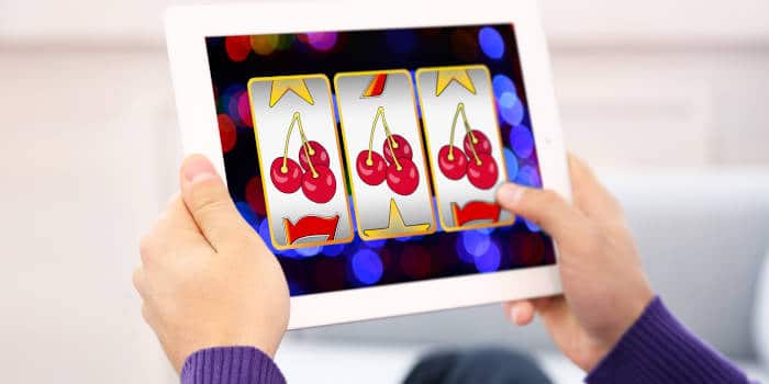 A person playing a slot game on his tablet.