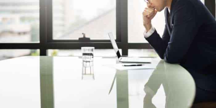 Businessman sitting on a table, thinking