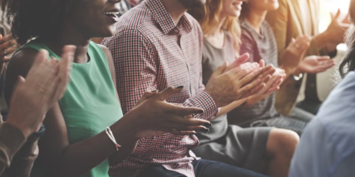 A group of people clapping