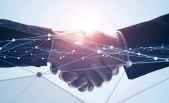 A concept for business network, close up photo of two businessmen shaking hands