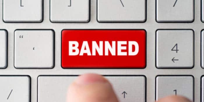 Button on computer keyboard with the word banned on it