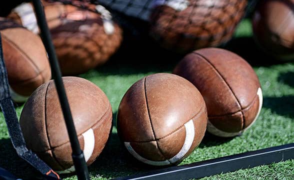 Several football balls lying on the ground