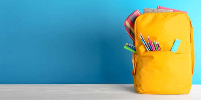 A school bag against a blue backdrop.