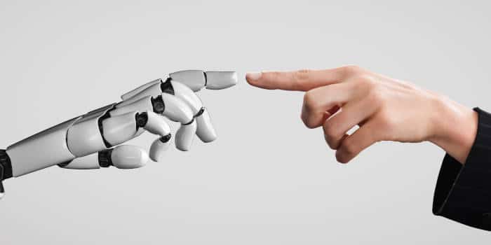 AI and human finger touching each other.