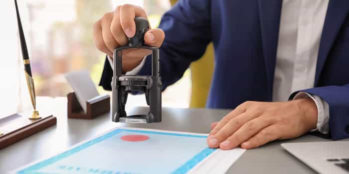 A businessman stamps a document