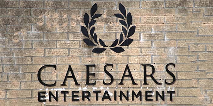 Caesars Entertainment's logo appears on a brick wall