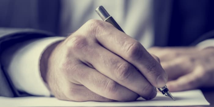 Businessman signing a document - close up photo