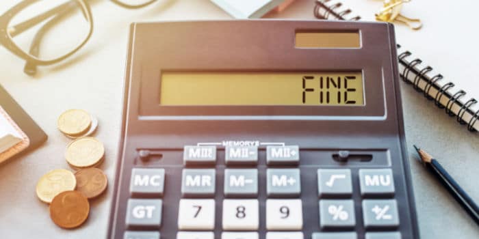 Calculator displaying the word fine, symbolizing financial penalty