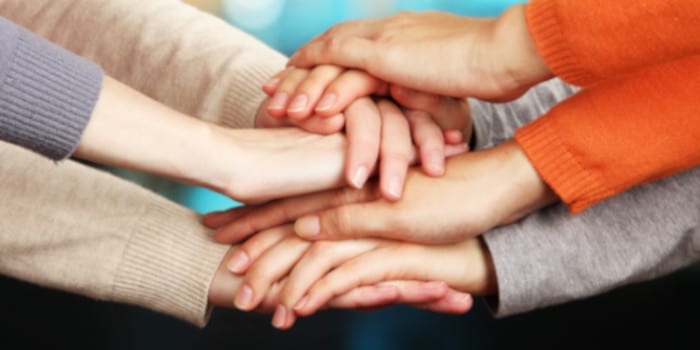 Human hands on a pile, symbol for teamwork