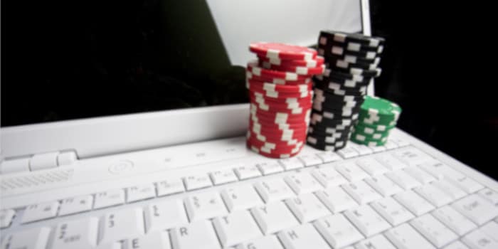 Poker chips stacked on a laptop