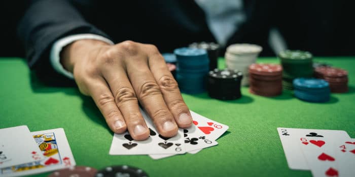 Close up photo of a man holding cards