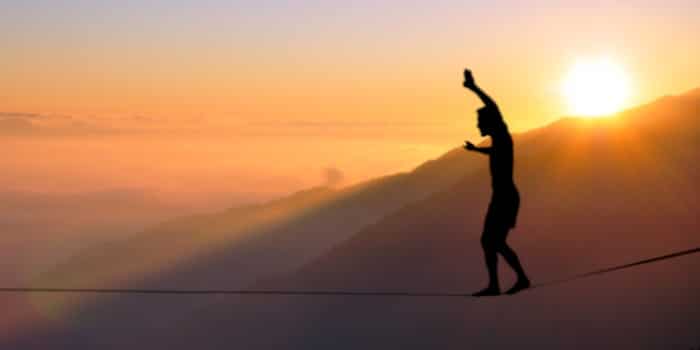 A man walking on a rope in the air