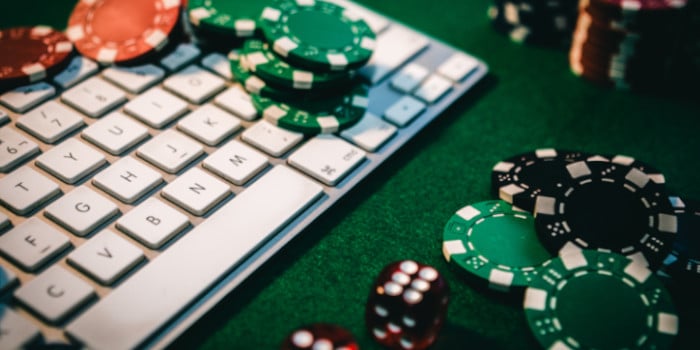 Poker chips and dice on top of a computer keyboard