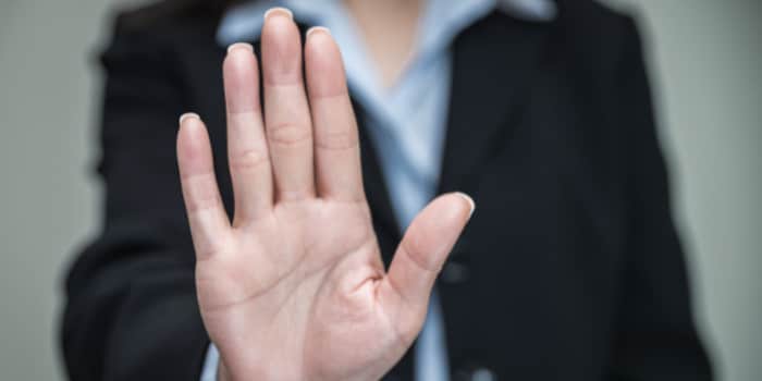 Businesswoman holding hand up as a stop gesture