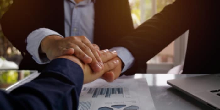 Three businessman shaking hands