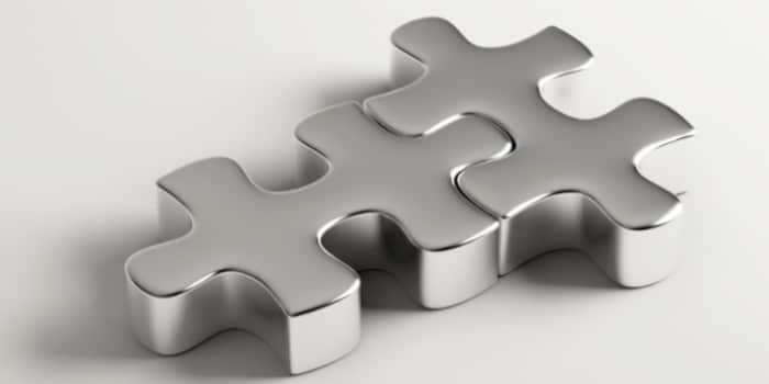 Two matching puzzle pieces joined together