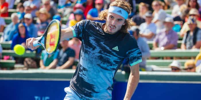 Stefanos Tsitsipas, a tennis player taking a bat.