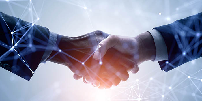 A concept for business network, close up photo of two businessmen shaking hands