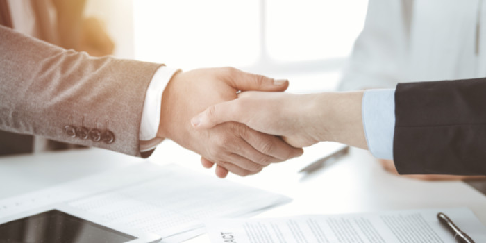 Businessman shaking hand with a businesswoman