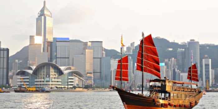 Hong Kong harbor with city in background and boat in the water