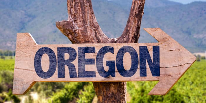 Oregon's sign on a tree.