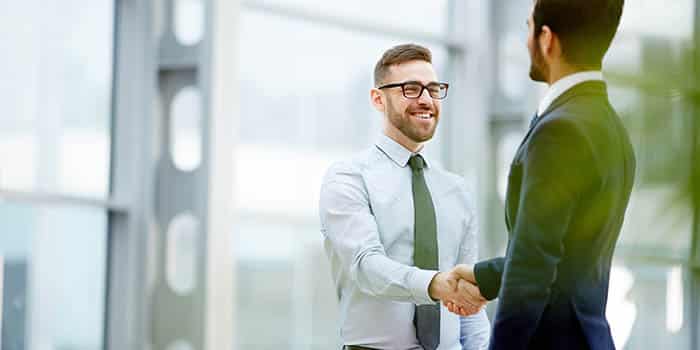 Two businessmen shake hands