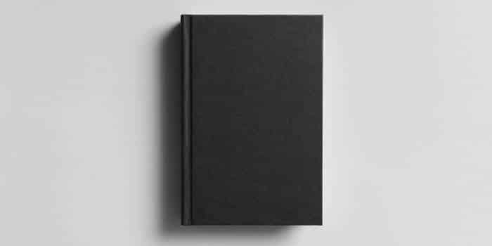 A black book against a grey background.