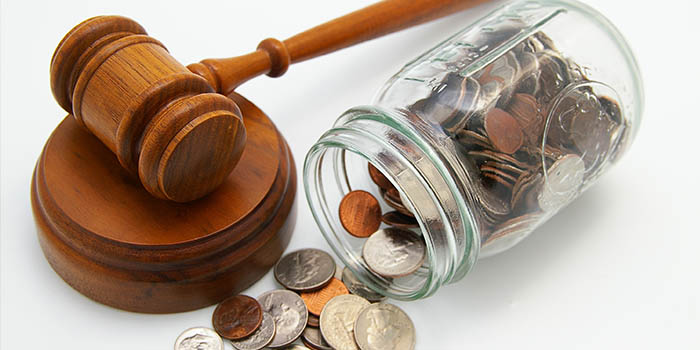 A wooden mallet next to a jar of coins