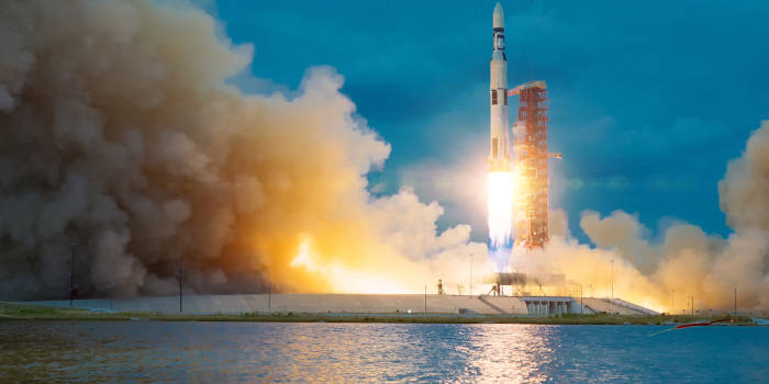 A rocket launching off a pad.