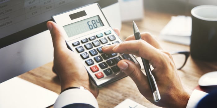 Businessman using a calculator, close up photo