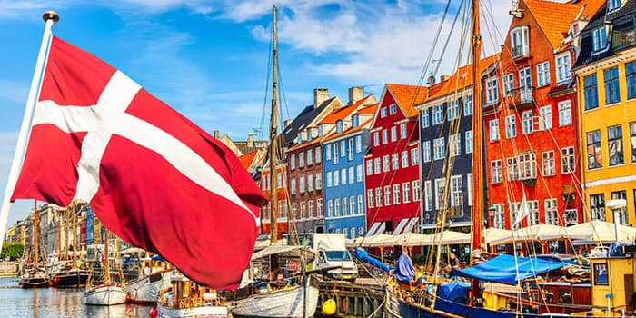 Danish flag flying against a background of yachts and boats.Danish flag flying against a background of yachts and boats.