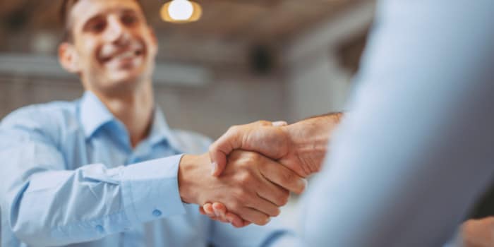 Two office members shaking hands