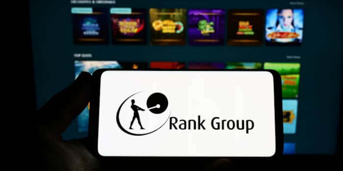 The Rank Group's website and logo on a smartphone.