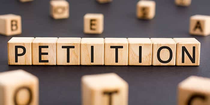 Wooden blocks spelling the word petition