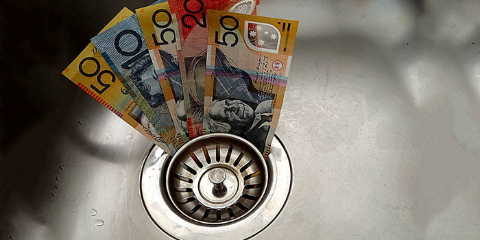 Australian dollar bills going down the drain