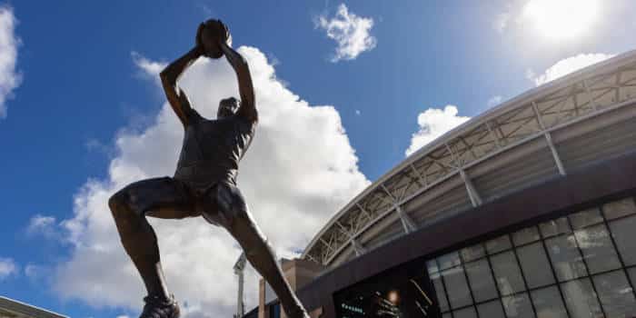 A statue of a national rugby league player.