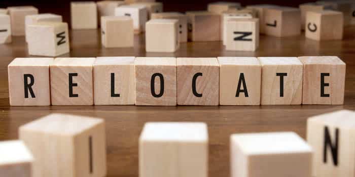 Wooden cubes spelling the word "relocate"