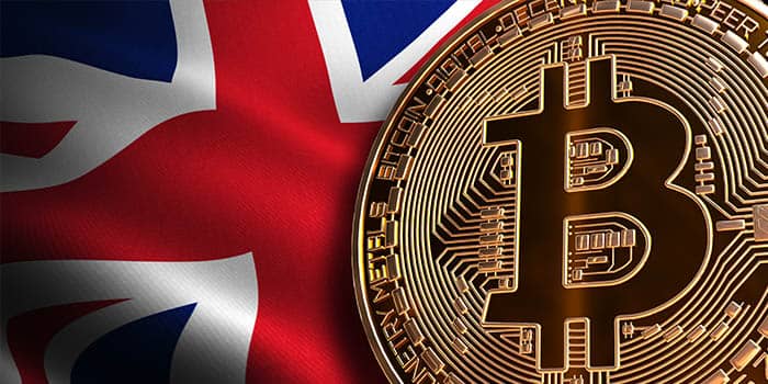 A bitcoin token with a British flag in the background