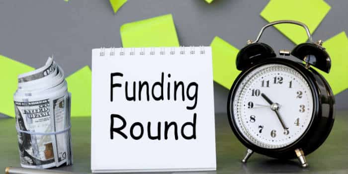 Funding round clock, sign and money.