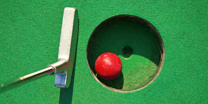 A mini-golf ball in a hole