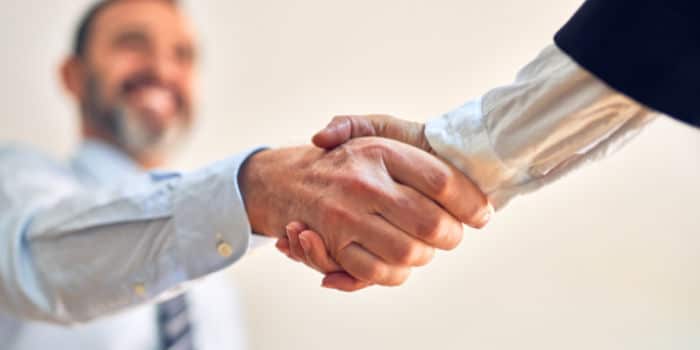 Two businessmen shake hands