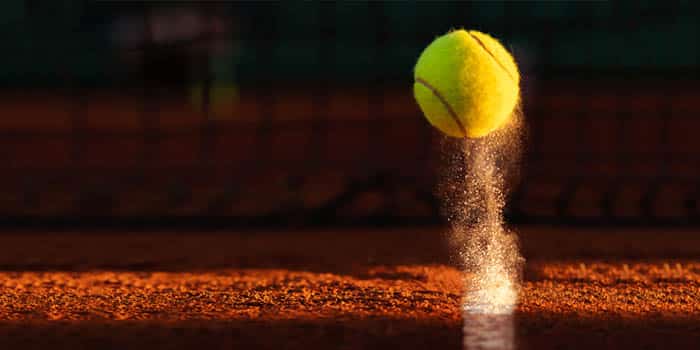 A tennis ball hits the ground