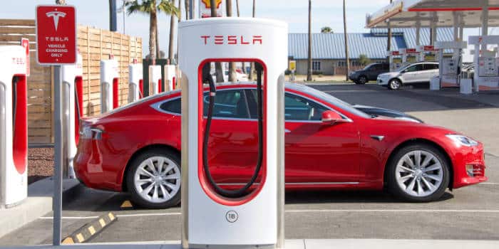 Tesla car parked next to a station.