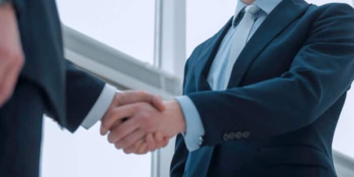 A close u photo of the hands of two businessmen in a handshake