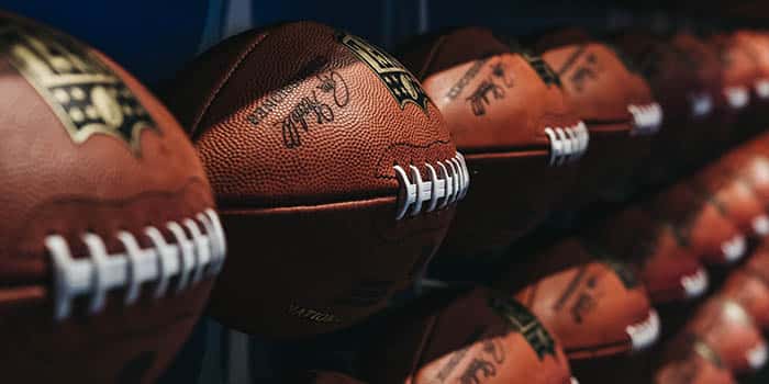 NFL balls on a shelf